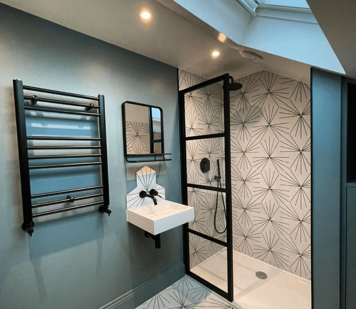 A modern bathroom space with a black heated towel rail