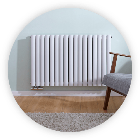 White Milano Aruba Flow designer radiator on a light green wall 