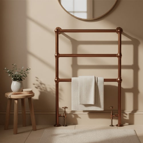 Brushed bronze heated towel rail in a bathroom